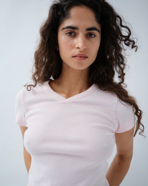 Close up of woman weating light pink v-neck tshirt