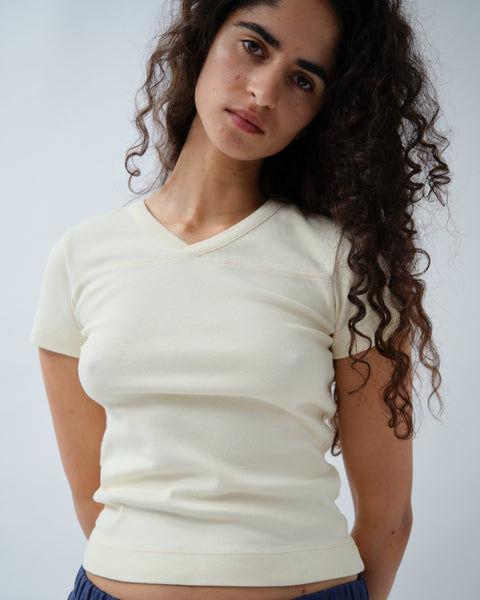 Front of woman wearing yellow v-neck tshirt