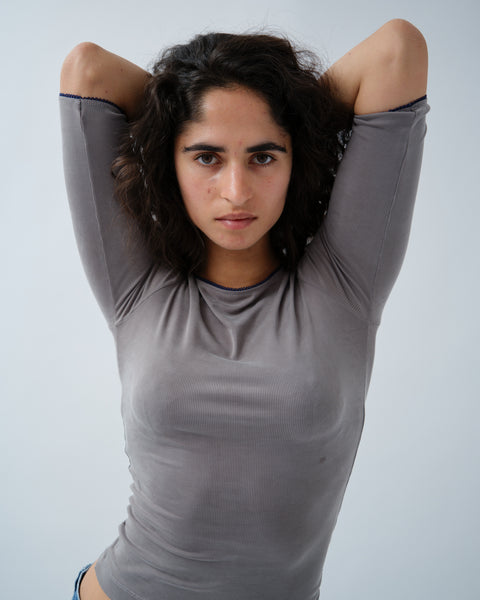 Front of woman in grey ribbed 3/5 sleeve top